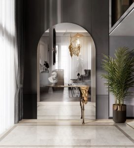 Modern luxurious hallway design with round mirror and gold console table.