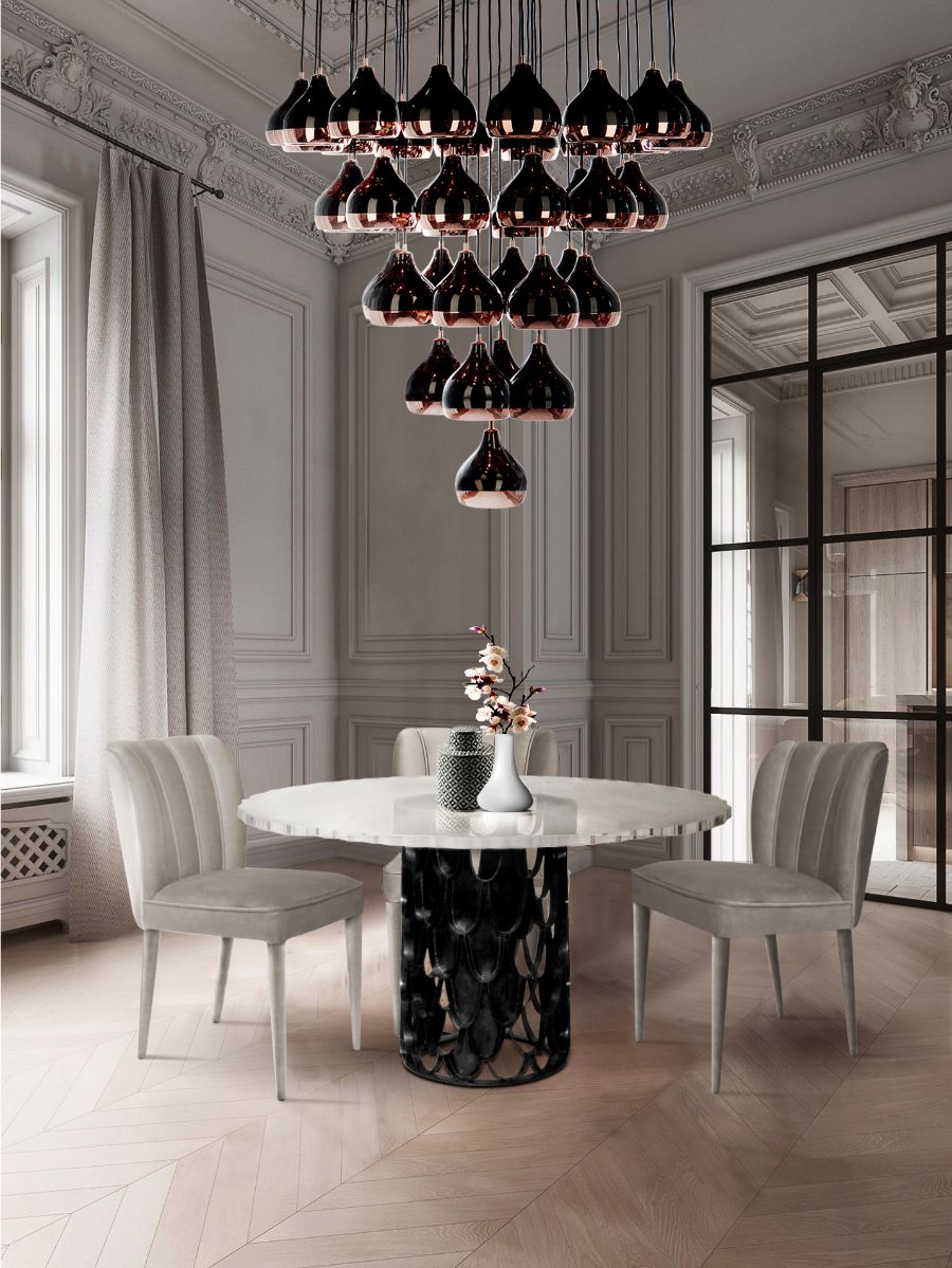 Modern Dining Room Decor in Black, White and Grey with grey velvet dining chairs, acrylic round dining table with black brass base