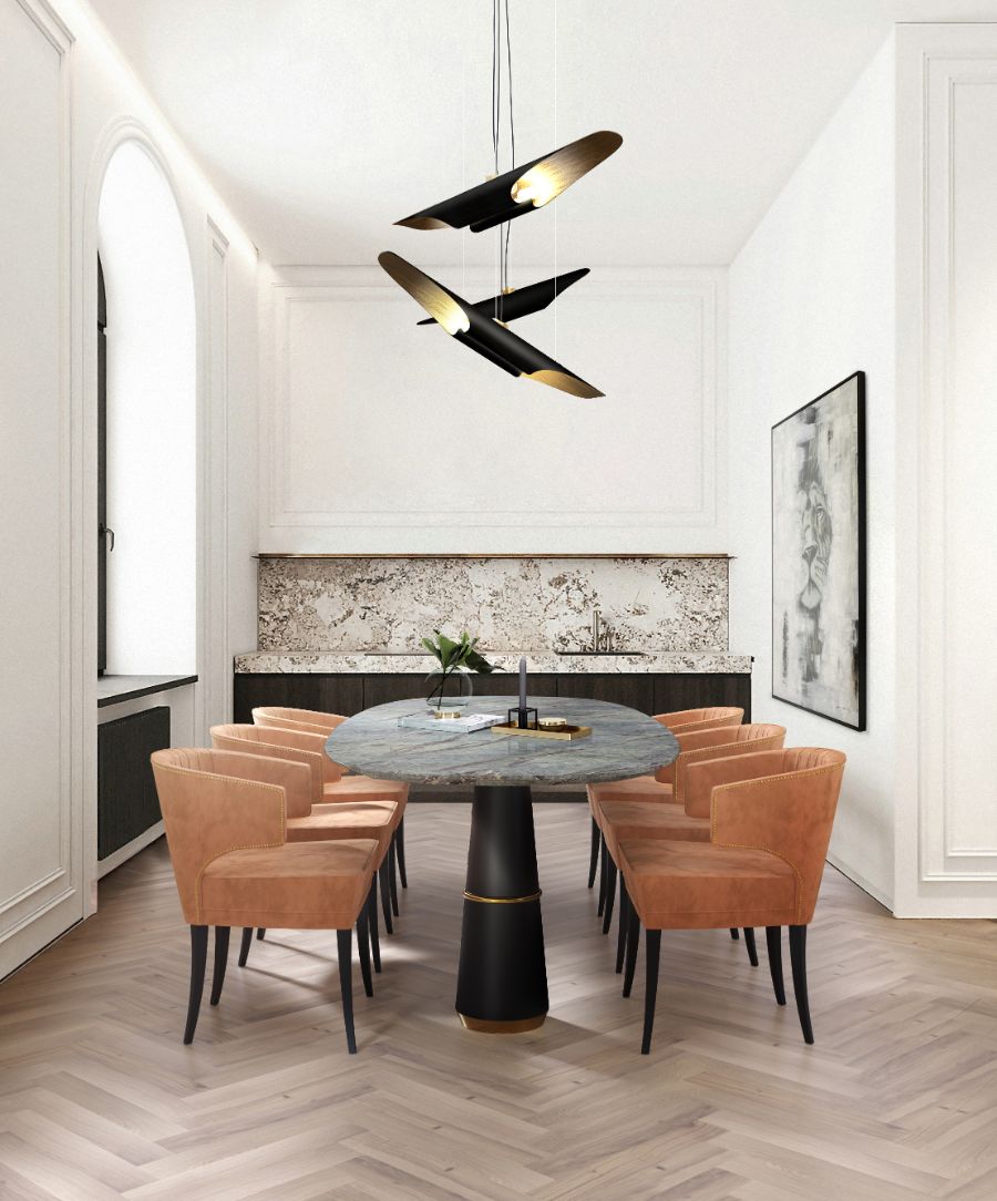 modern dining room design with orange upholsteed dining chairs and marble dining table