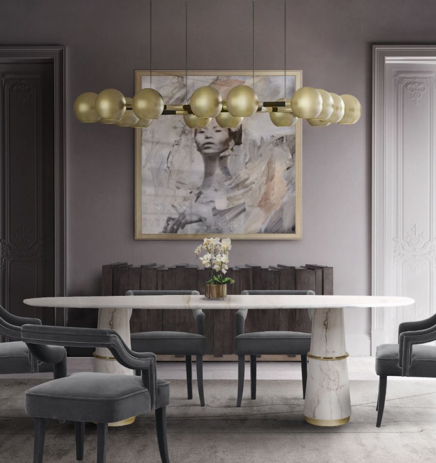 contemporary dining room with oval white marble dining table and grey velvet dining chairs