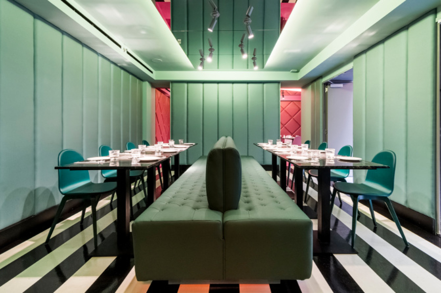 restaurant with green furniture and dining chairs, black dining tables