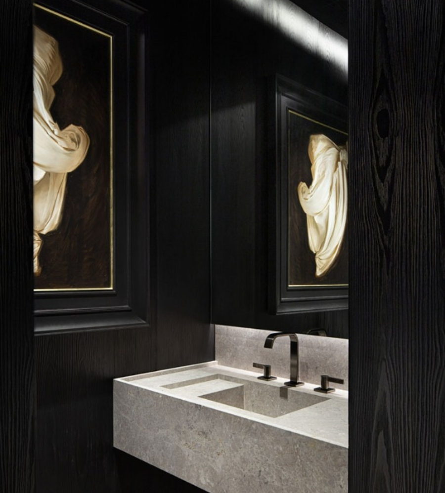 The Best Interior Design Ideas By Audax. This luxurious bathroom in black walls has a golden paiting and a grey marble sink.