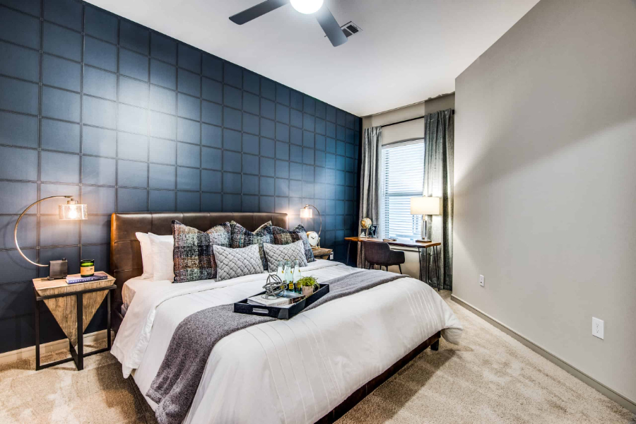 SJL Design Group: Interior Design In Texas. This bedroom has two bedside tables, and a small working area on the corner, with a desktop table and a chair.