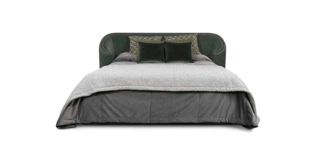 Wales Bed fully upholstered in velvet with decorative nailhead detailing, creating a luxurious and elegant bedroom centerpiece.